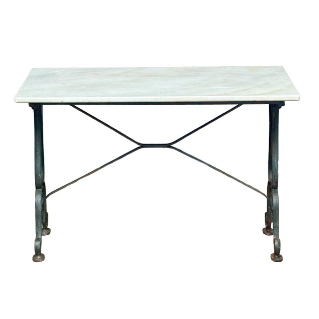 A fine Parisienne bistro table from the Belle Époque era, featuring a rectangular figured white marble top set upon a...