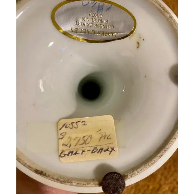 A pair of antique rose medallion candlesticks from 1860 in excellent condition. There is what appears to be an old price...