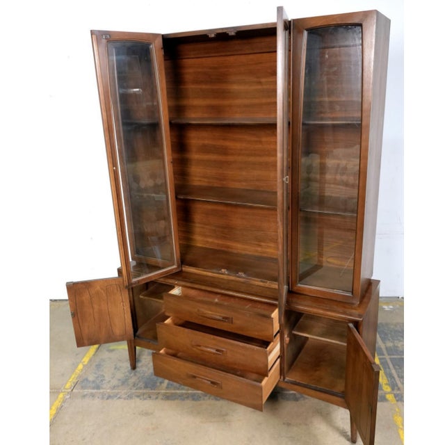 Elevate your dining or living space with this iconic 1960s Broyhill Emphasis two-piece china cabinet. Renowned for its...
