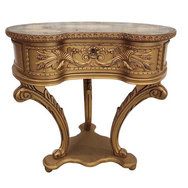 Petite and ornate, this vintage Italian end table features a kidney-shaped top with a decorative motif sealed beneath a...
