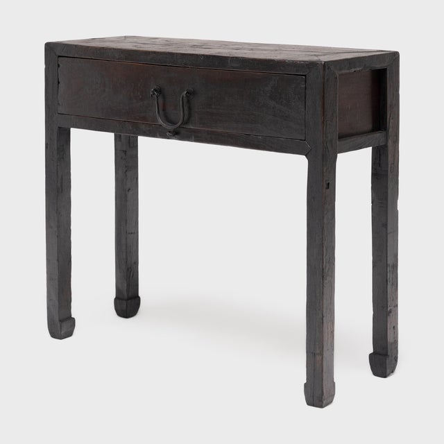 Dated to the late 19th century, this clean-lined console table was likely used as a small offering table or as a dressing...
