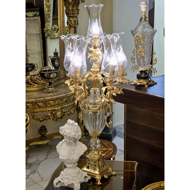 Make a dramatic statement with this ornate French-style candelabra lamp, featuring an elaborate gilded structure, faceted...