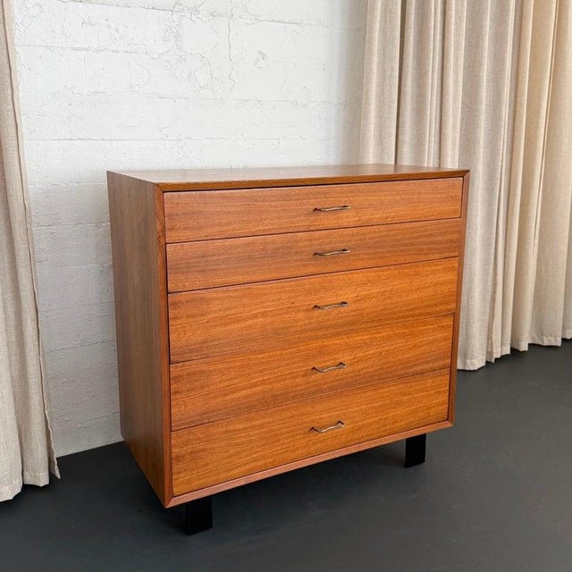 This iconic five drawer walnut dresser was designed by George Nelson for Herman Miller. The dresser follows the classic...
