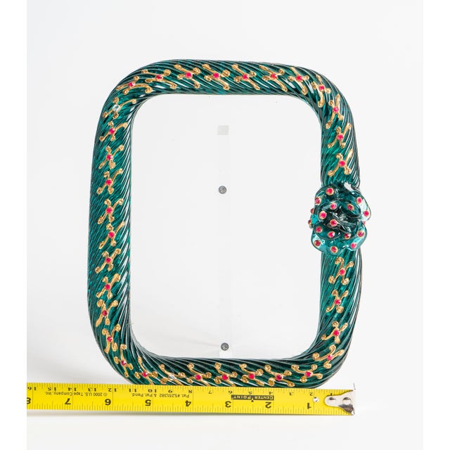 A vibrant vintage Murano glass picture frame from Venice, formed as a twisted emerald green rope of glass and accented...