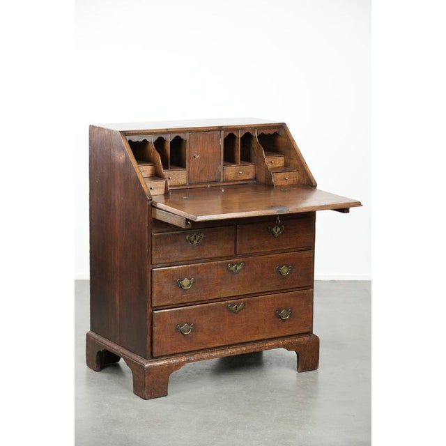 We are offering this elegant 18th-century antique English oak secretary desk with a beautiful stepped interior. This...