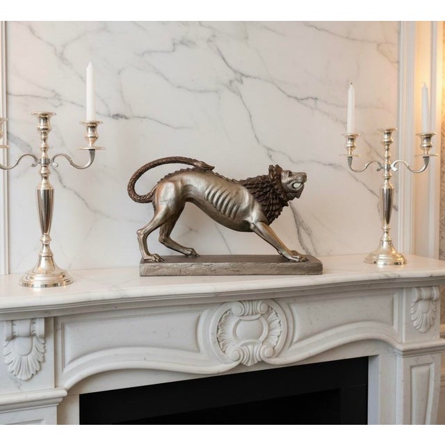 A dramatic large-scale Etruscan lion sculpture by Austin Productions, dated 1987 and made in the United States. Inspired...