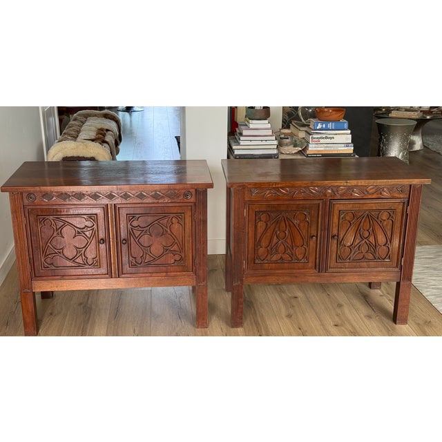 A rare and captivating pair of Gothic Revival two-door cabinets, each handcrafted by Maurice Roland Schmidt, Ph.D., in his...