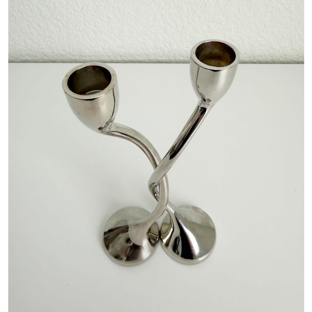 A pair of postmodern chrome candlesticks with organic form, inspired by Spanish maker art3's work produced in the 1970s....
