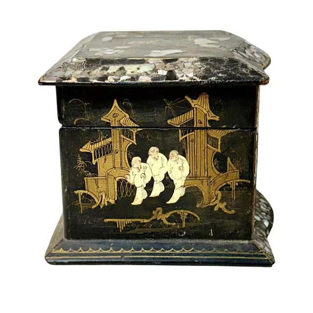 A richly decorated 19th century Japanese jewelry box crafted in black lacquer with extensive mother of pearl inlay and...