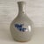 Antique ceramic bottle vase with cobalt blue blossom vine motif on opposite sides. Rustic charm originally made for...