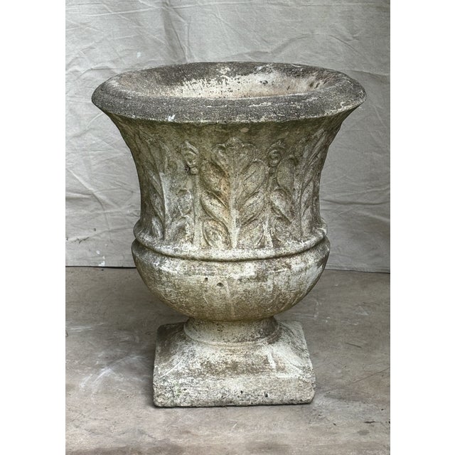 A substantial mid century cast stone garden urn with a bold acanthus leaf relief and square plinth base. Hand poured in a...