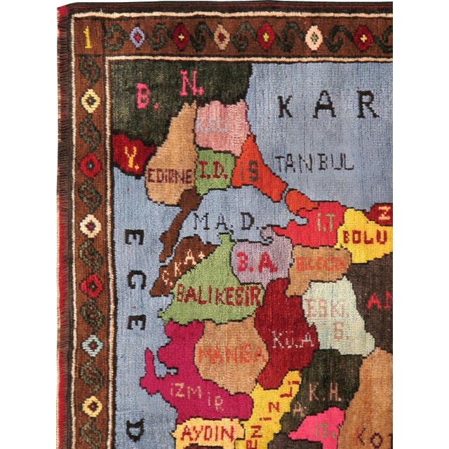 A vintage Turkish Pictorial carpet from the second quarter of the 20th century depicting a map of Turkey. Measures: 4' 2"...