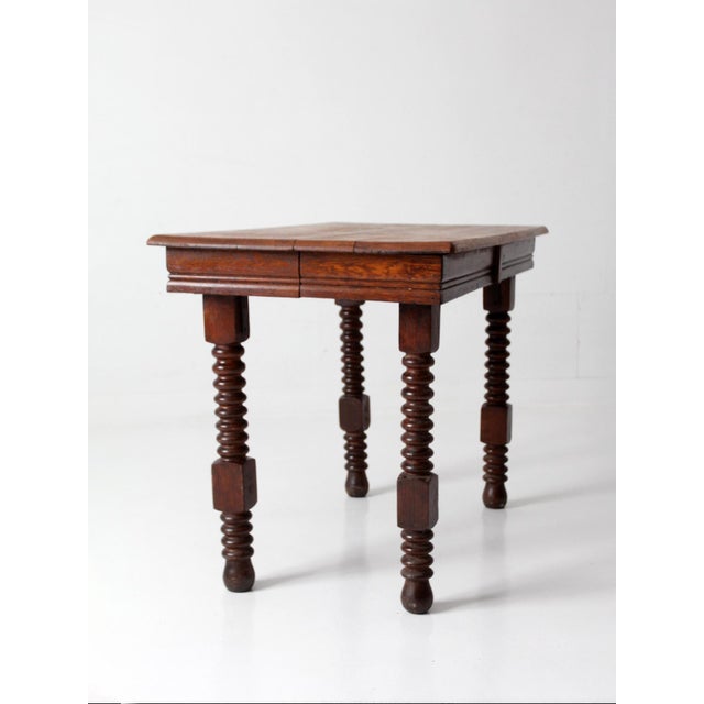Antique Jacobean Revival table dating to the late 19th century, featuring barley twist legs and a solid plank top. The...
