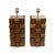 A striking pair of sculptural table lamps crafted from solid teak wood, featuring its characteristic warm brown tones and...