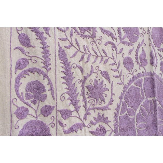 This striking textile is an authentic Suzani (suzan is Persian for "needle"), hand-embroidered by women in Central Asia,...