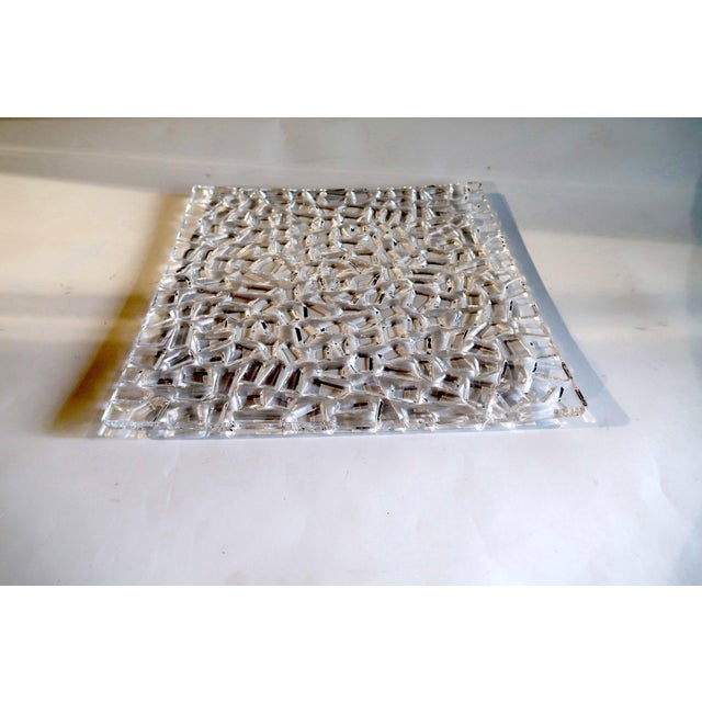 Heavy crystal serving plate with faceted cut throughout and acid etched brand stamp at underside This piece has an...