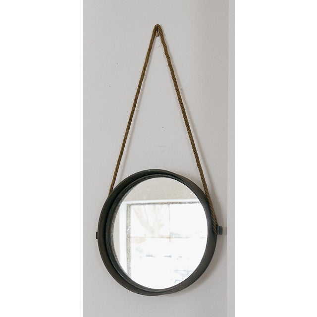 Vintage round metal mirror on a golden colored silk rope, France. This piece is the perfect decorative mirror. The metal...