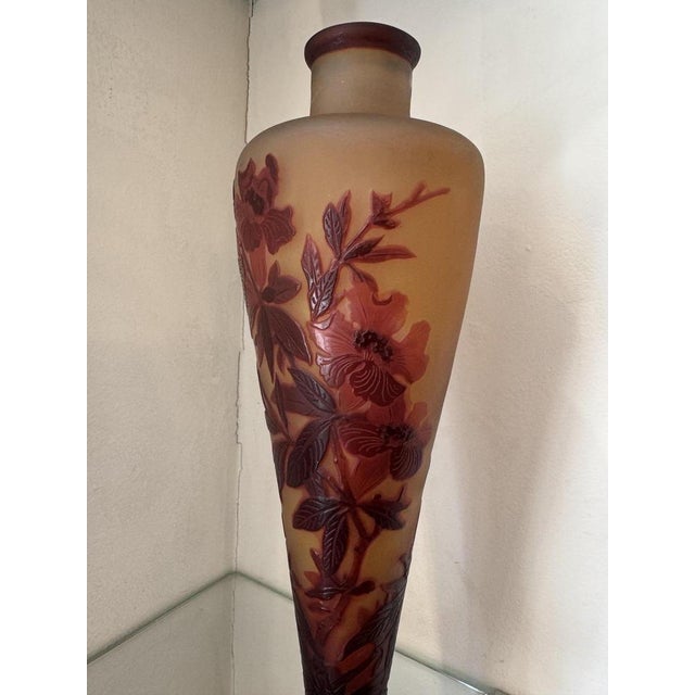 An elegant, signed lamp base by Gallé, crafted from multi-layered cameo glass. The slender stem is adorned with a finely...