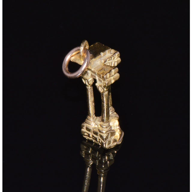 This detailed Roman Forum column ruins charm is crafted in solid 18K yellow gold and designed as a three-dimensional...
