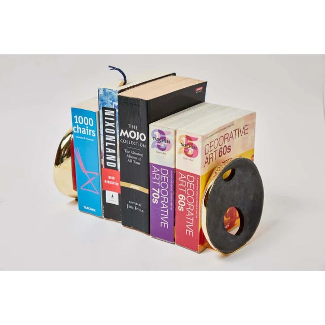 Large Carl Aubock Model #4101 'Méliès' Patinated Brass Bookends. Designed in the 1950s, this incredibly refined and...