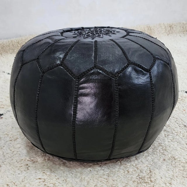 Introduce a bold and sophisticated accent to your space with this handcrafted Moroccan leather pouf cover, skillfully made...