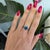 A solid natural boulder opal cabochon flashes with vivid play of color across this solid 14K white gold ring, accented by...