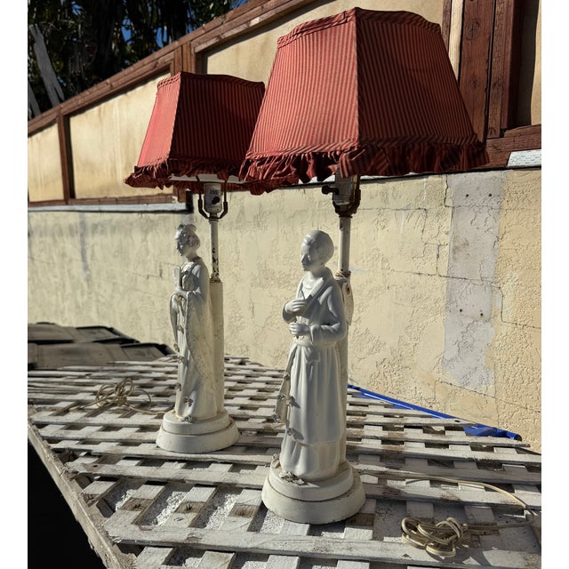 Beautiful Pair of Mid-Century Porcelain Figural Lamps with Custom Pleated Striped Shades A charming matched pair of...
