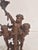 Bronze sculpture depicting three cherubs (putti) in a lively, upward-reaching composition. The figures are gracefully...