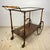 Mid-Century wood bar cart trolley made in Italy in the 1970s. Dark brown wood, glass. Good vintage condition. Dimensions:...