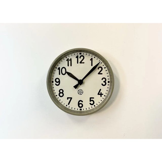 This factory wall clock wad produced by Chronotechna in former Czechoslovakia during the 1950s. It features a grey metal...