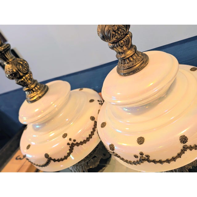 Beautiful Mid Century large iridescent glass lamps . They are decorated with brass draping all around each glass body. The...