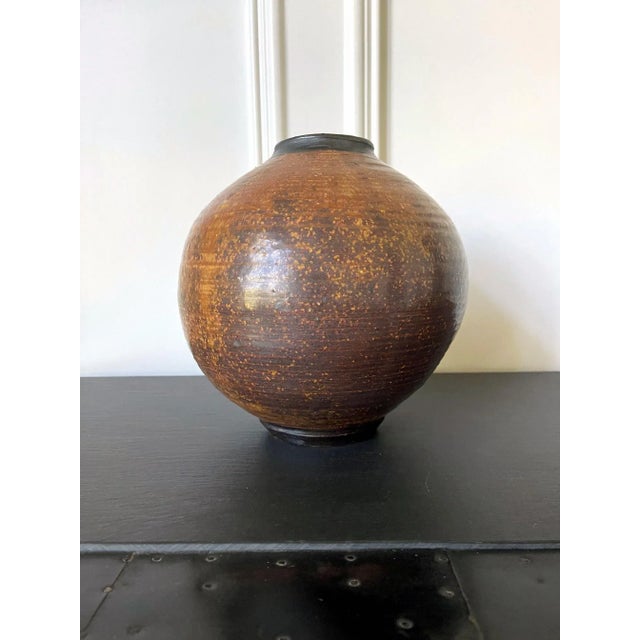 A ceramic vase in the form of a "moon jar", a nearly sphere shape with small base and mouth. The form was celebrated in...