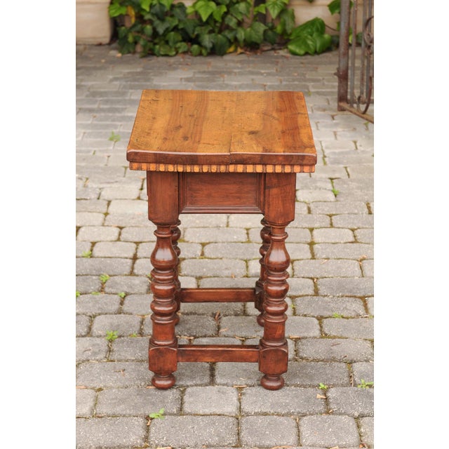 An Italian walnut side table from circa 1870, with dentil molding and turned base. Born in Italy during the third quarter...