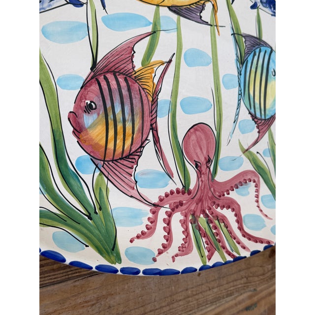 Bring a splash of the Mediterranean home with this vibrant hand-painted Vietri oval wall platter featuring a whimsical...