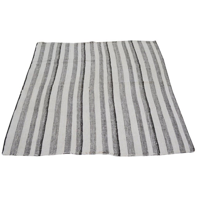Hand-knotted with care using traditional rug-making techniques, this wool rug blends timeless craftsmanship with a modern...