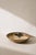 A sculptural stoneware bowl by Søholm featuring expressive hand-applied glaze decoration in earthy tones. The flowing...
