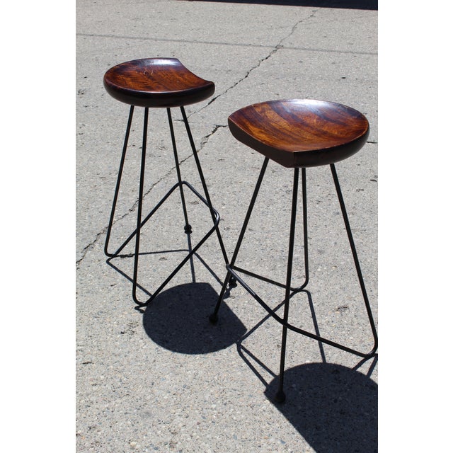 An amazing pair of barstools attributed to Gretta Grossman. These fine pieces are comprised of black iron frames with...