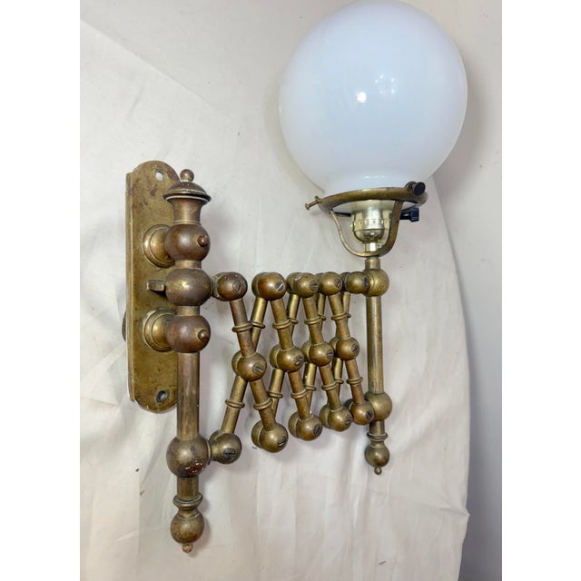 Up for sale is an exquisite antique expandable brass industrial wall sconce. This lamp features a gold color that has...