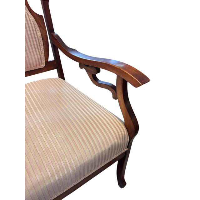 Elegant antique Victorian parlor armchair from the later 19th century to early 20th century, 1890-1910, featuring a richly...