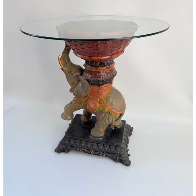 Whimsical glass-top accent table with elephant base. Glass top is removable and base can be used to hold fresh or faux...