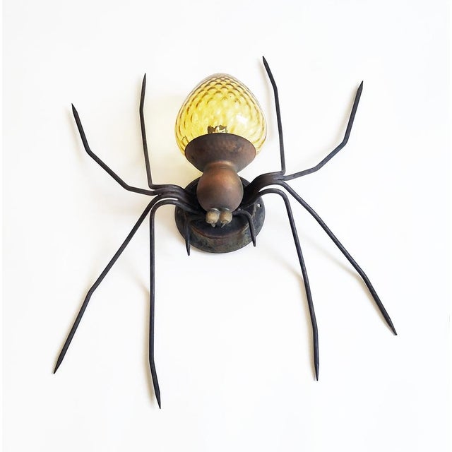Gorgeous mid-century modern outdoor wall light from Italy from the 1950s, made from forged iron, copper and a golden-amber...