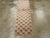 This mid-20th century Turkish Anatolian runner, measuring 1' 10" x 6' 8", showcases a charming and delicate floral lattice...