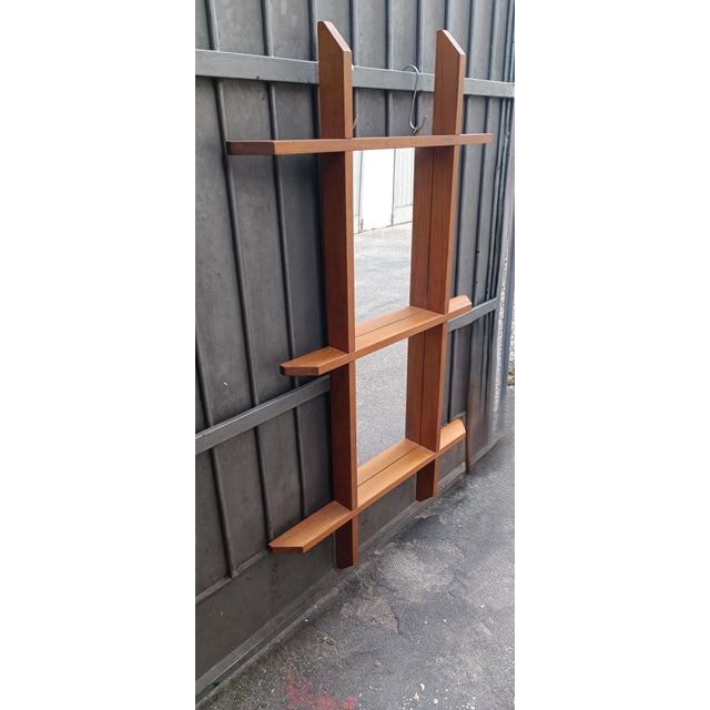 Mirror in the shape of a Swedish painting with a wooden frame that, when viewed from the front, is deliberately elongated...