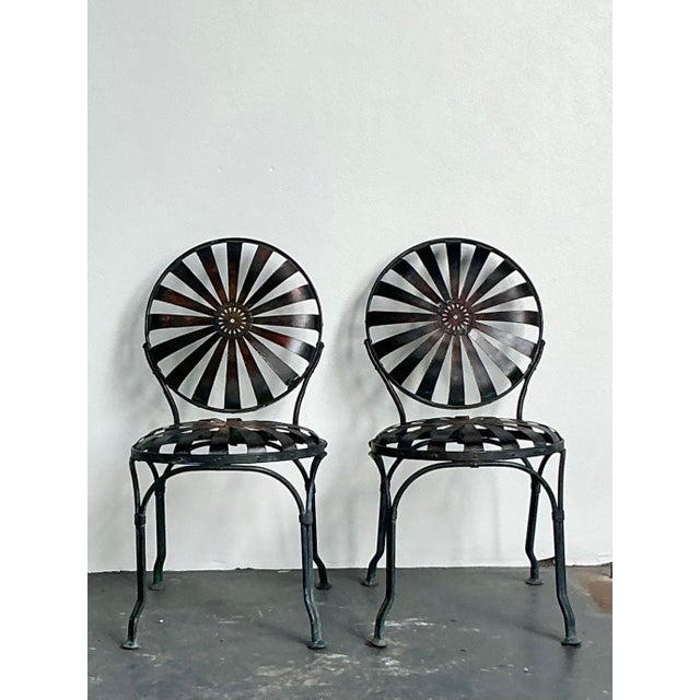 These striking vintage wrought iron dining chairs capture the elegant, kinetic energy of the iconic "sunburst" designs...