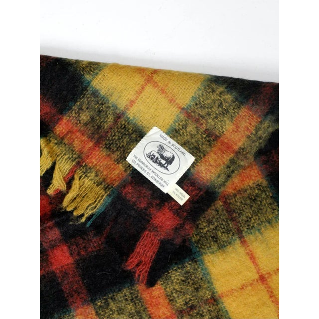 Vintage Scottish wool plaid blanket or wrap by Edinburgh Woollen Mill featuring a classic tartan pattern in yellow, red,...