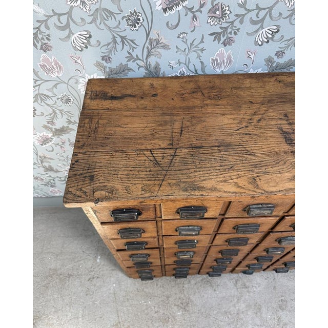With its incredible 70-drawer front and preserved history, this antique solid oak workshop cabinet is a rare piece from...