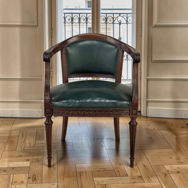 An antique French Louis XVI armchair by Hirler of Alsace, crafted in mahogany, pairs neoclassical elegance with the...