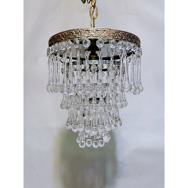 Add dramatic elegance and a warm vintage glow to your interior with this magnificent vintage mid-century tiered brass...