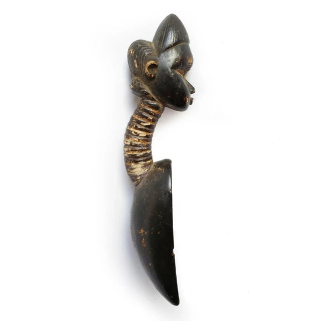 Old Dan Bassa spoon from Liberia. Traditional Dan figure head shaped handle with ringed neck design. Signs of age and use....