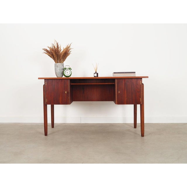 The desk was made in the 1960s, Danish production. The structure and the top are covered with teak veneer. The solid wood...